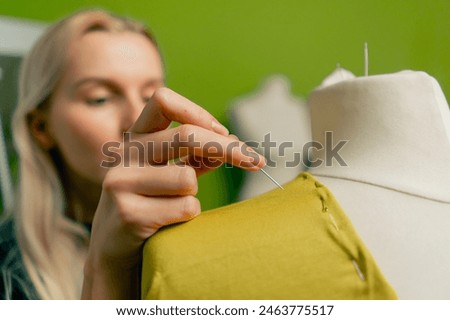 close-up in the sewing workshop of two transparent jars with a crayons for working on fabric