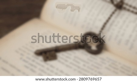 A close-up, shallow depth of field shot of an antique, ornate skeleton key lying on the pages of an old, weathered book.