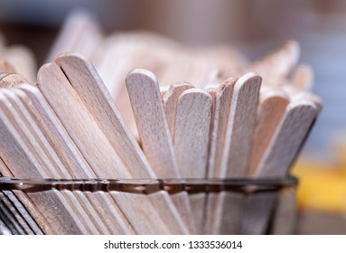 Closeup And Shallow Depth Of Field View Of A Bunch Of Paddle Pop Sticks Placed In A Glass Jar (top Portions). Useful In Arts And Crafts As Well As In Food Applications. Made From Light Balsa Wood.