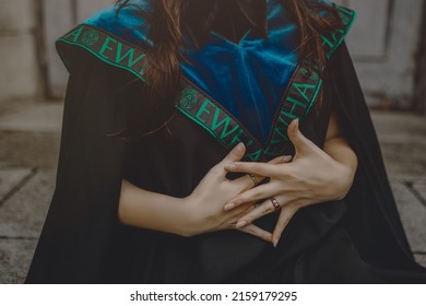 A Closeup Shallow Focus Shot Of  Graduated Girl's Hands And Elegant Mantle