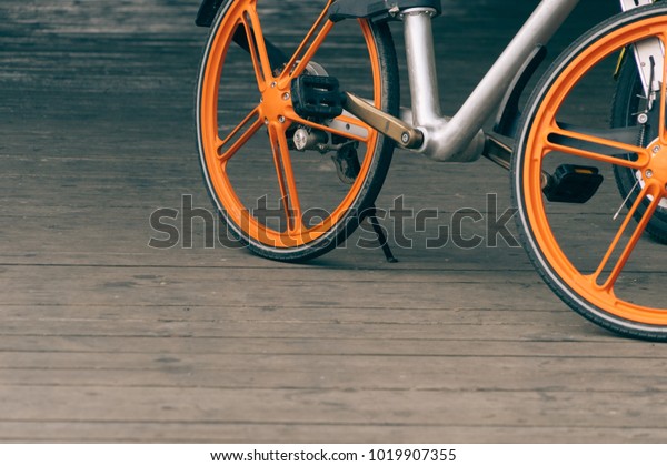closeup of a\
shared bicycle parked on\
sidewalk\
