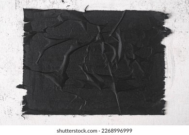 Close-up of a sheet of black paper with folds.