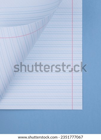 Close-up sheet of a notebook in a slanting ruler