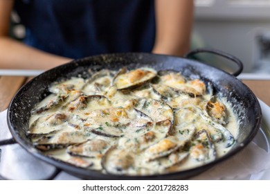 A Closeup Of A Shellfish Dish With A Cream Sauce On A Pan