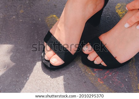 A closeup shhot of a girls fet in black sandals