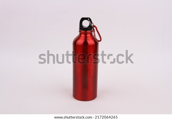 Close-up of shiny\
red reusable steel thermos water bottle, isolated on a white\
background with copy space. Zero waste. Say no to single-use\
plastic bottles. Environmental\
concept.
