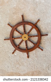 close-up of the ship's steering wheel on a wall background