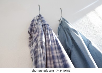 Close-up of shirts hanging on hook against wall - Powered by Shutterstock