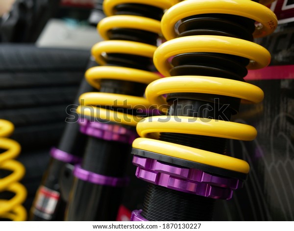 closeup of shock\
absorbers of car at\
garage.