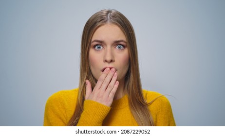 Closeup Shocked Woman Face Looking Camera. Portrait Scared Girl Standing In Studio. Worried Lady Shock Face Expression In Slow Motion. Upset Female Model Grey Background. Shocked Customer User