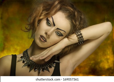 Close-up Shoot Of  Fashion Dark Punk Lady With Creative Purple Make-up And Studs Accessories  