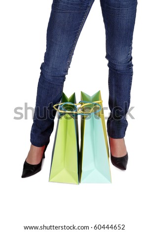 Close-up of shopping bags between two feet