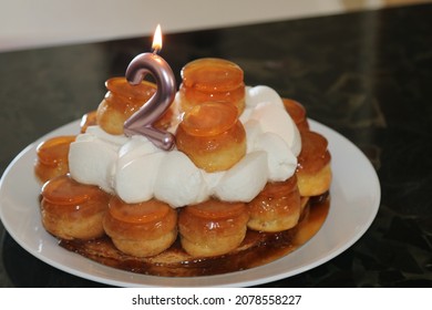 A Closeup Shot Of A 2nd Birthday Cake With Profiteroles