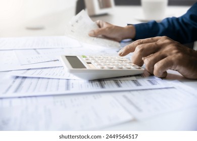 Close-up shot. asian men hand using calculator to calculate expenses and tax to recive tax reduction for personal individual Income. tax return concept for individual person 