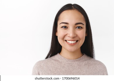 Close-up Shot Asian Woman Face With No Pimples, Acne, Natural Make-up, Smiling Joyful, Feeling Happy And Upbeat, Having Lucky Day, Enjoy Spend Weekends In Family Circle, Having Conversation