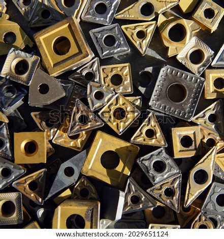 A closeup shot of indexable carbide inserts as a background
