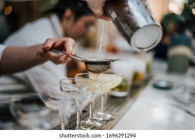 A Closeup Shot Of A Barman Making Margaritas With Four Glasses Set In Line