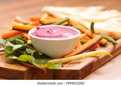 A Closeup Shot Of Beet Dip With Fresh Baked Naan Flatbread, Vegetable Sticks For Dipping