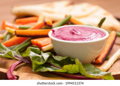 A Closeup Shot Of Beet Dip With Fresh Baked Naan Flatbread And Vegetable Sticks For Dipping