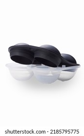 Close-up Shot Of A Black 4 Piece Silicone Ice Ball Mold With A Lid. The Spherical Ice Cube Mold Is Isolated On A White Background. Front View.