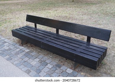 A Closeup Shot Of A Black Metal Bench In A Park