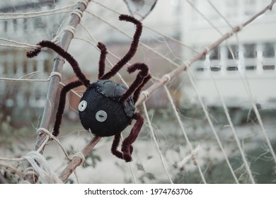 A Closeup Shot Of A Black Toy Spider On A Fake Spider Web