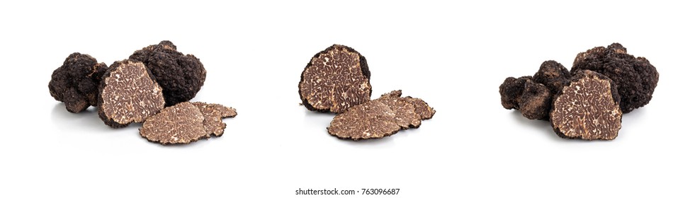 Closeup shot of black truffles and oak leaves isolated on white background.