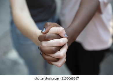 A close-up shot of a black and white woman's hands - the concept of diversity - Shutterstock ID 2153068867