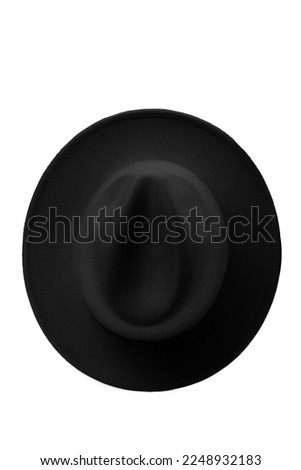 Close-up shot of a black wide-brimmed fedora. A black men's felt fedora hat is isolated on a white background. Top view.