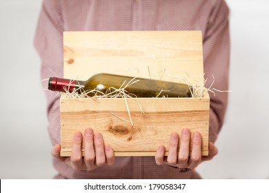 Closeup Shot Of Blurred Man Holding Wooden Box With Wine In Focus