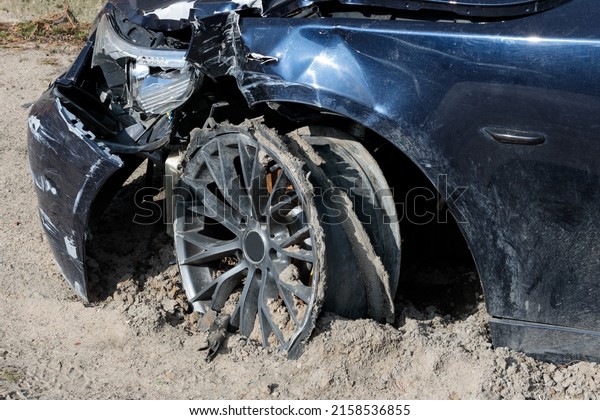 A\
close-up shot of a broken car stuck in the dry ground\
