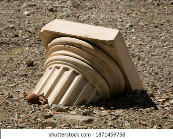 A Closeup Shot Of A Broken Greek Column On The Floor