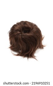 Close-up Shot Of A Brown Detachable Chignon. The Chignon Hairpiece Made Out Of Brown Synthetic Hair Is Isolated On A White Background. Front View.