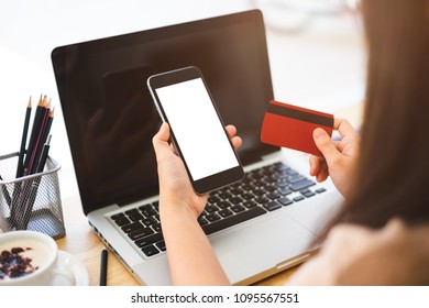 Closeup shot of an businesswoman using his smartphone at home to make online purchases with his credit card
