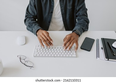 Close-up Shot Busy African American Man In Casual Navy Shirt And Typing On Keyboard With Wireless Mouse, Concept Remote Job