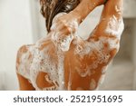 A closeup shot captures a person thoroughly enjoying a refreshing and invigorating shower with bubbly soap