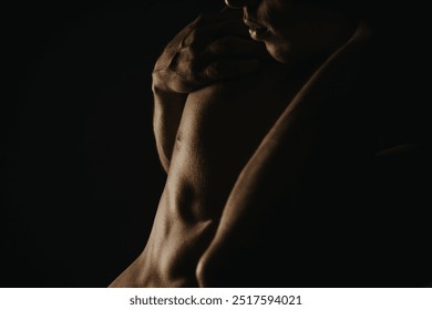 Close-up shot capturing the details of a muscular male torso with dramatic lighting emphasizing muscles and skin texture, exuding strength and masculinity. - Powered by Shutterstock