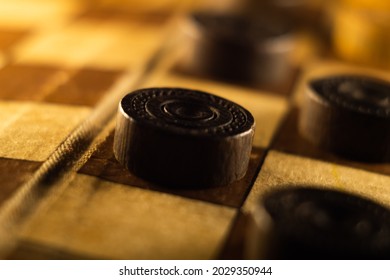 A Closeup Shot Of A Checkers Board And Wooden Game Pieces On It