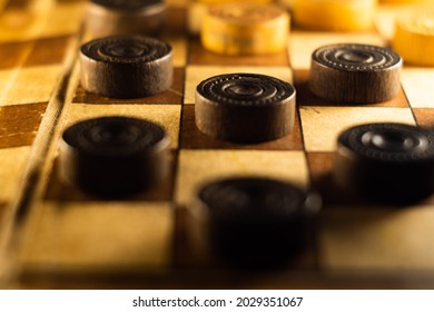 A Closeup Shot Of A Checkers Board And Wooden Game Pieces On It