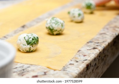 A closeup shot of cheese balls on puff pastry sheets