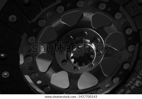 Close-up shot of clutch disk and basket on\
dark background