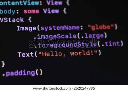 A close-up shot of code displayed on a dark screen, featuring the classic 'Hello, world!' program. Ideal for illustrating software development, programming concepts, and technology-related themes