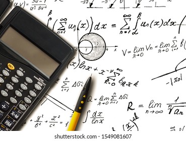 Closeup shot of complex math formulas on paper with calculator and ball pen aside.