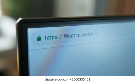 Close-up shot of a computer screen displaying the search query "What to watch?". Online browsing, digital content consumption, and internet navigation. - Powered by Shutterstock - Get 15% off with code: PIKWIZARD15