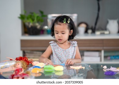 A Closeup Shot Of A Cute South Asian Child Playing At Home