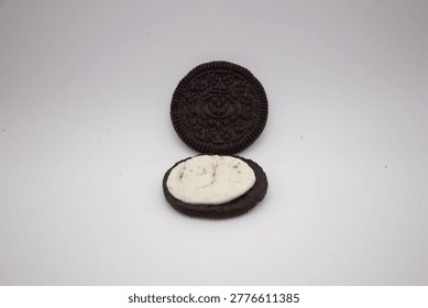 A close-up shot of a delectable, opened cookie revealing its creamy filling, offering a tantalizing glimpse into its sweet interior