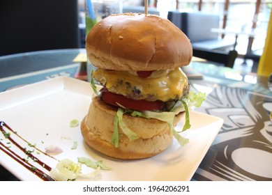 A Closeup Shot Of A Delicious Tall Burger