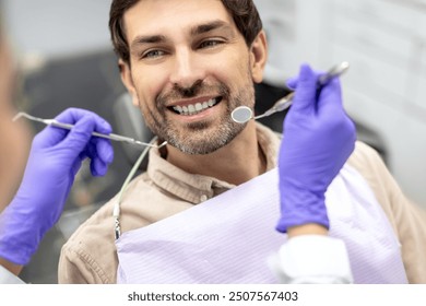 Closeup shot of dentist examining male patients teeth in dental clinic. Man having his teeth examined by female dentist - Powered by Shutterstock