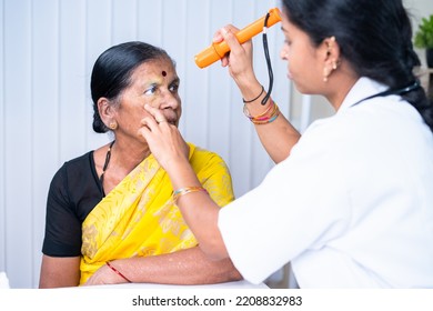 Closeup Shot Of Docter Checking Or Obesering Patient Eye During Body Checkup At Hospital - Concept Of Healthcare, Mediacal Service And Professional Occupation.