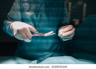 A close-up shot of a doctor in surgical gloves, holding a scissors, ready for a procedure - Powered by Shutterstock